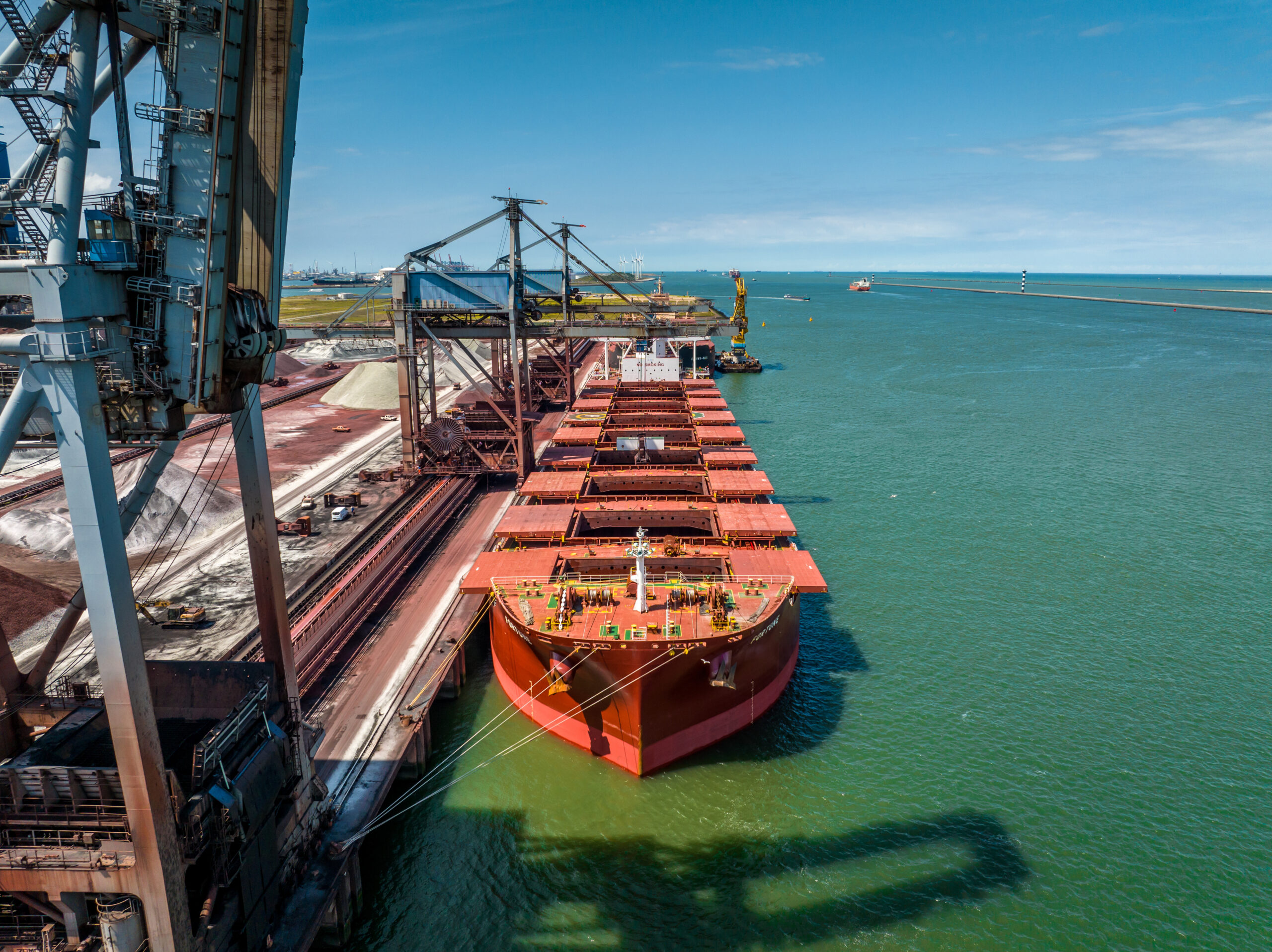 general cargo ship docked at berth at a terminal